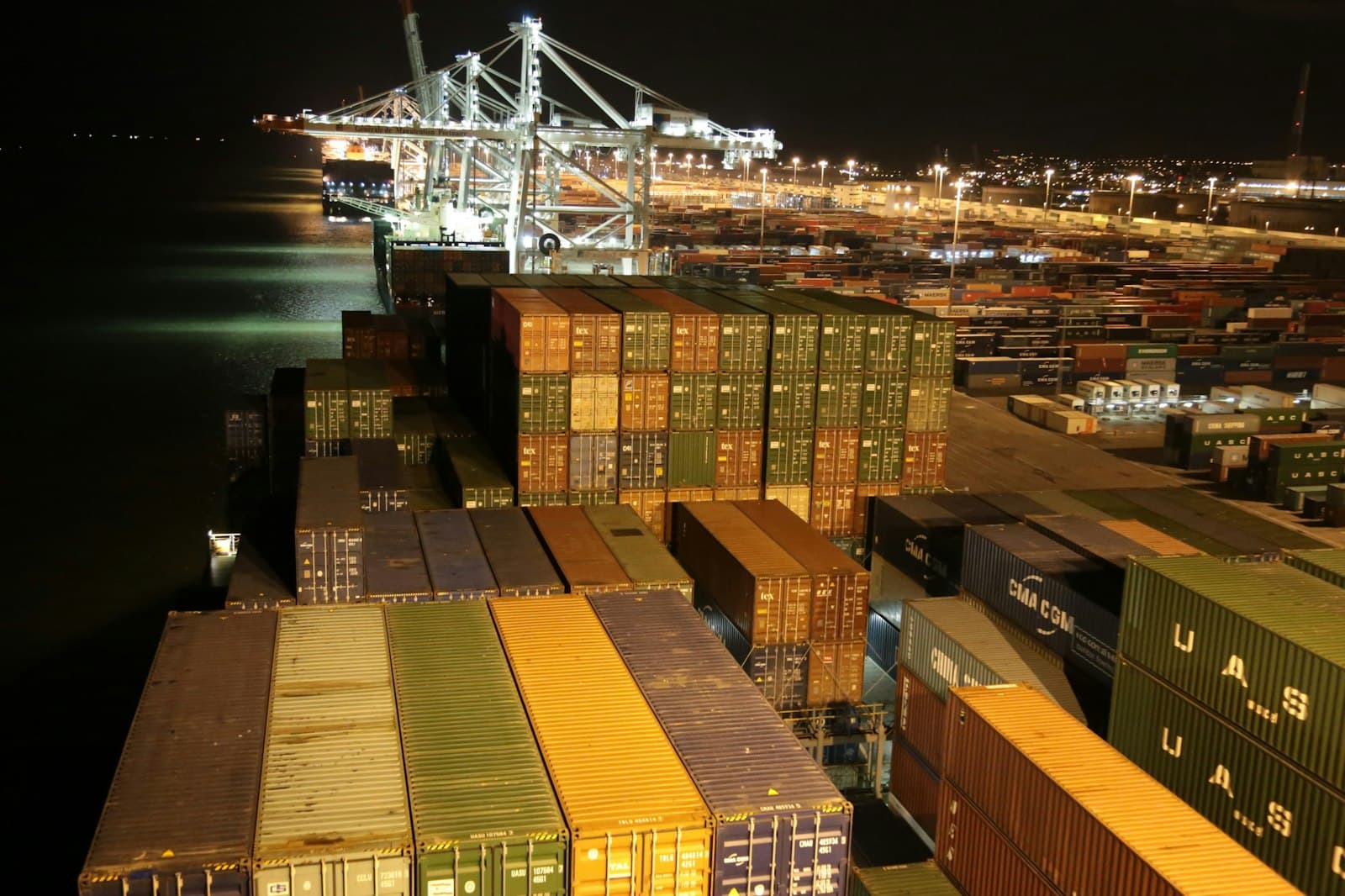 Container stacks under floodlights at night