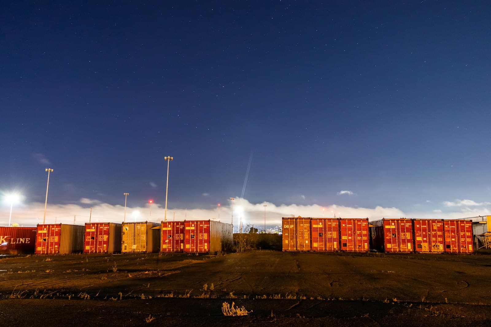 Container stacks under night lighting at a bonded terminal