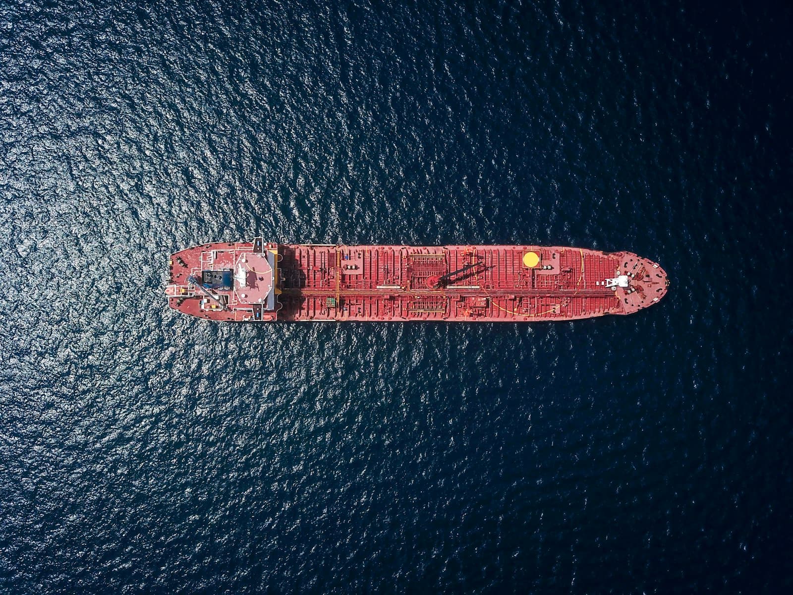 Aerial view of a container vessel on dark open water